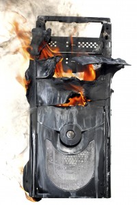 burning computer case isolated on white